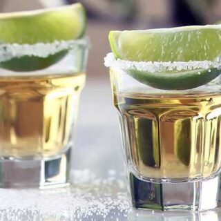 1.5 oz shot glasses with tequila, lime wedge and salt rim