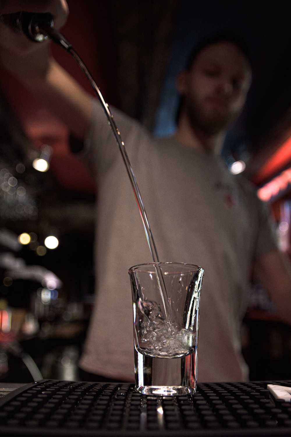 Silver tequila poured in a tall shot glass