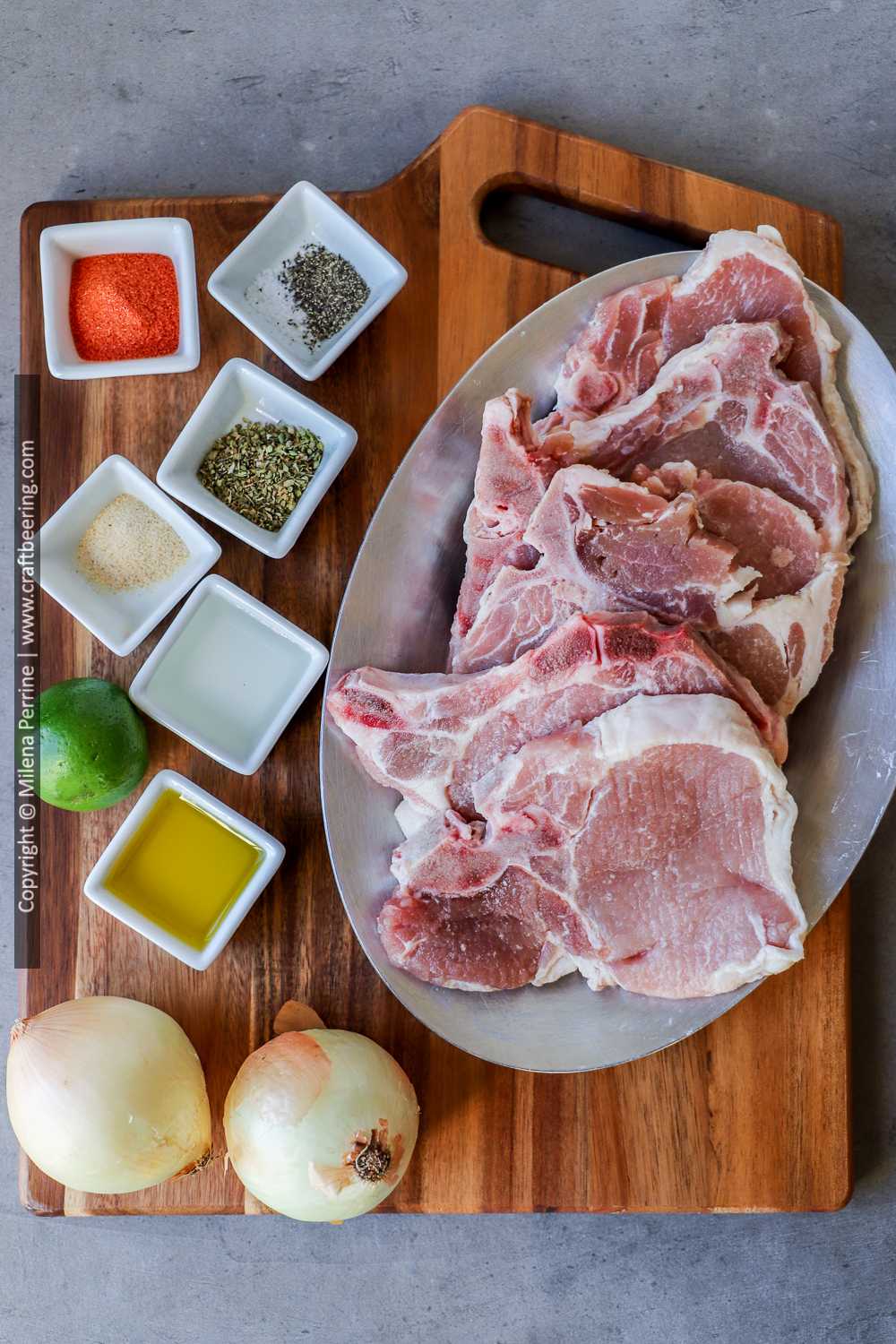 Thin pork rib chops and other ingredients for chuletas fritas fried pork chops recipe from the Carribean nations. 