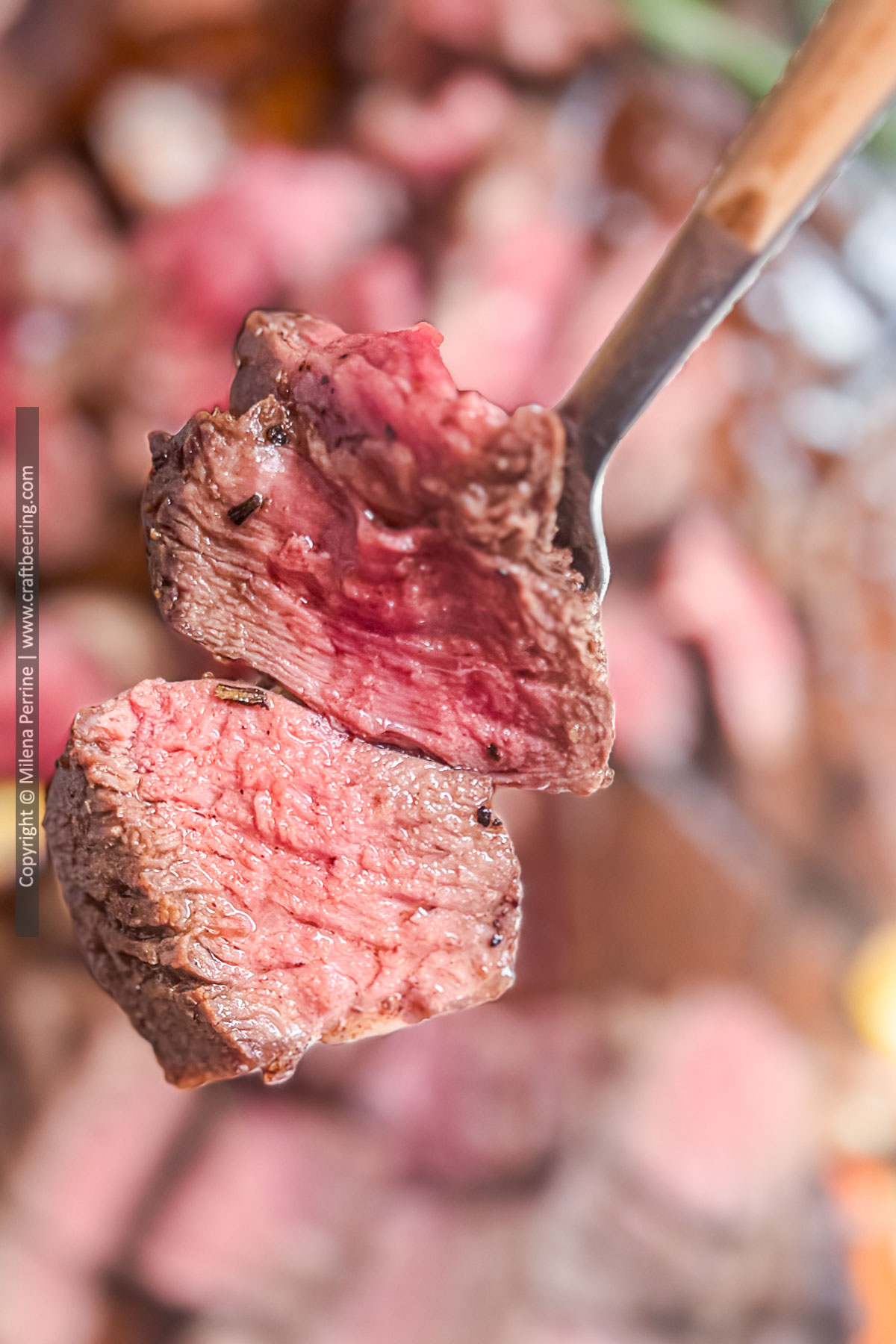 Close up of two pieces of chuck eye steak - one cooked medium-rare and the other one medium.