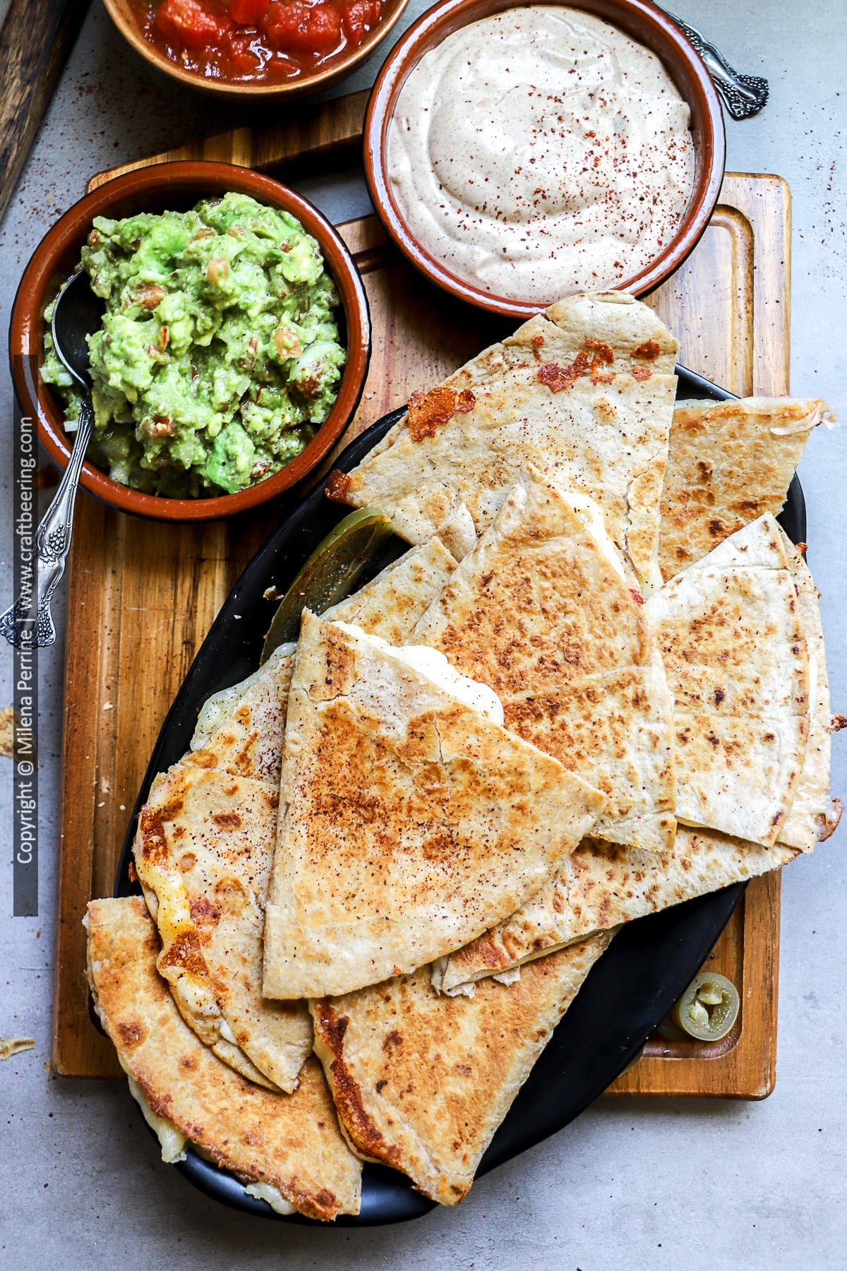 Cheese quesadillas served with guacamole, quesadilla sauce and salsa.