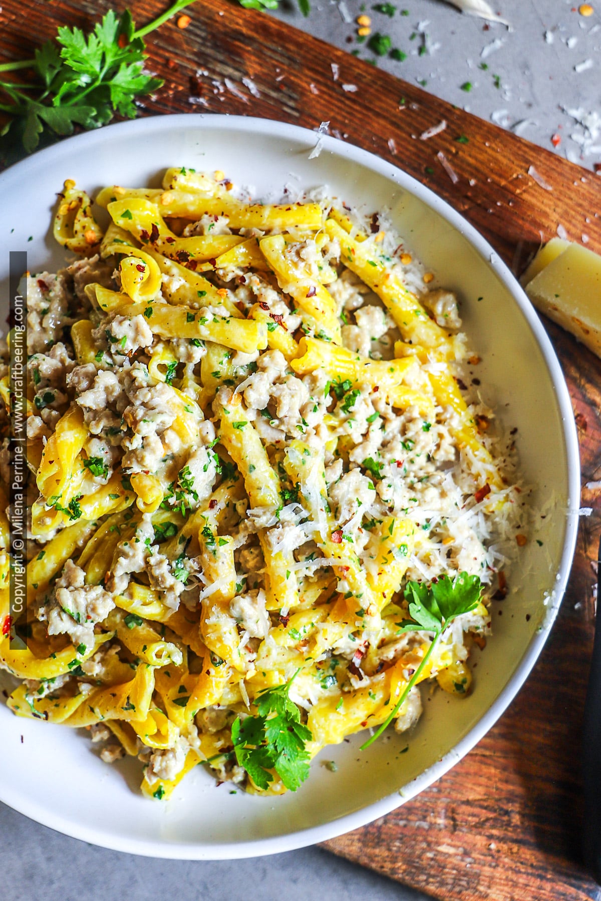Creamy ground chicken pasta served in a white pasta bowl.