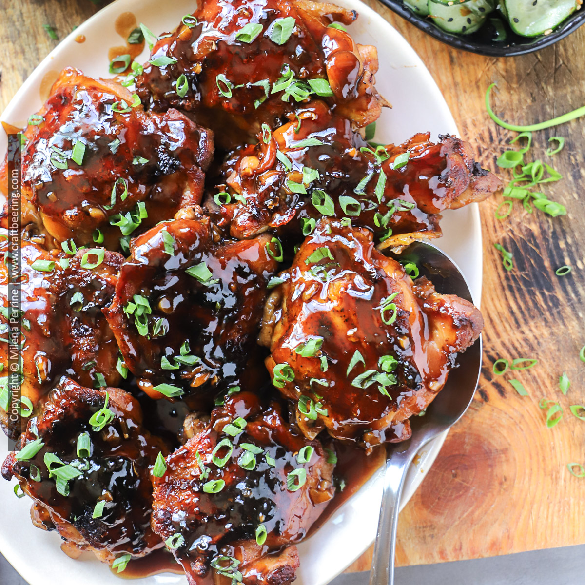 Hawaiian chicken with soy sauce glaze, known as shoyu chicken, served on a platter and garnished with thinly sliced green onions.
